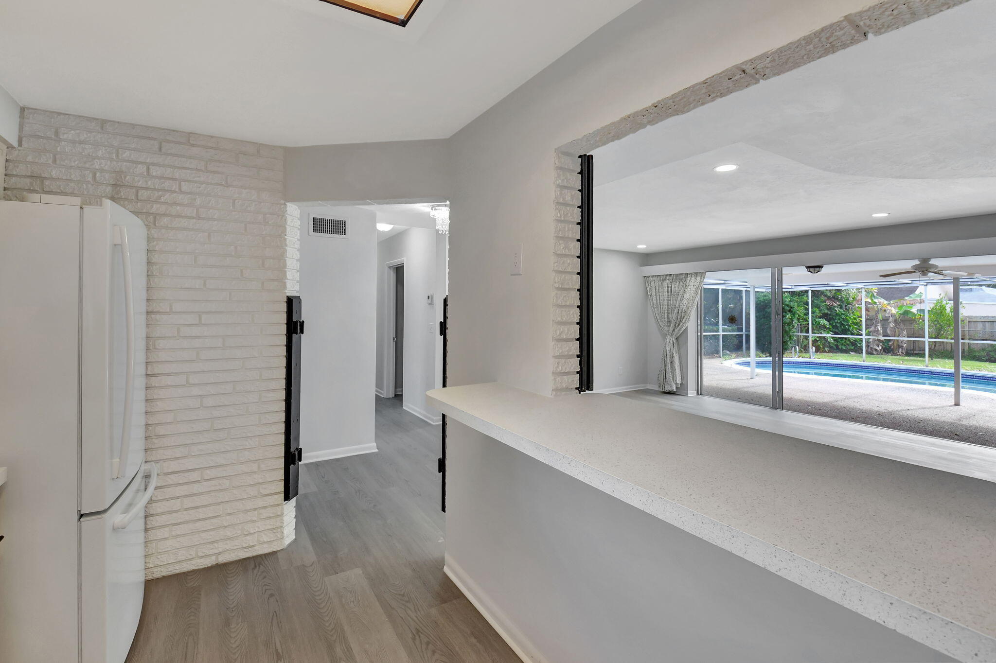 410 Spanish River Boulevard Boca Raton, FL 33431 - Photo 11 of 26 a view of hallway with a large window and wooden floor