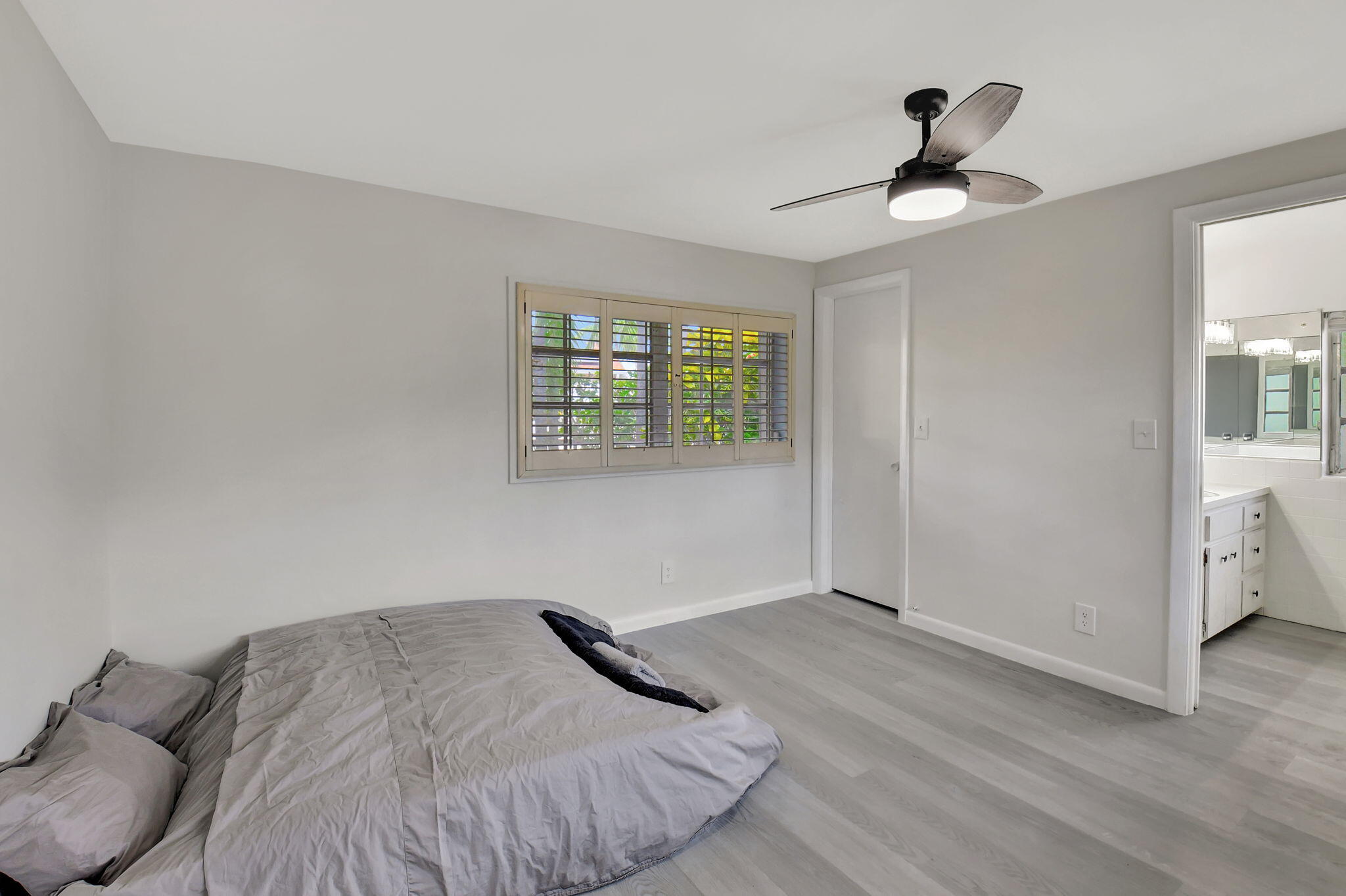 410 Spanish River Boulevard Boca Raton, FL 33431 - Photo 16 of 26 a bedroom with a bed and a chandelier