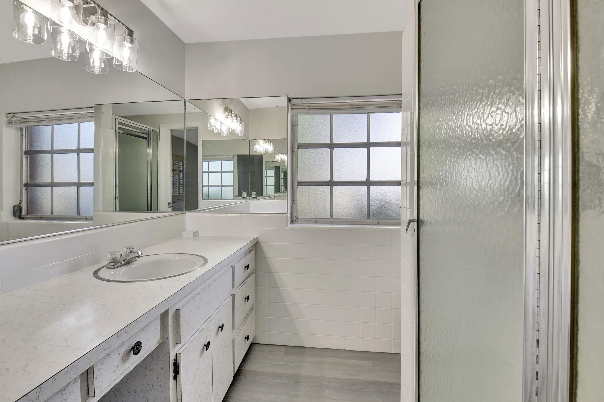410 Spanish River Boulevard Boca Raton, FL 33431 - Photo 17 of 26 a bathroom with a sink and a mirror