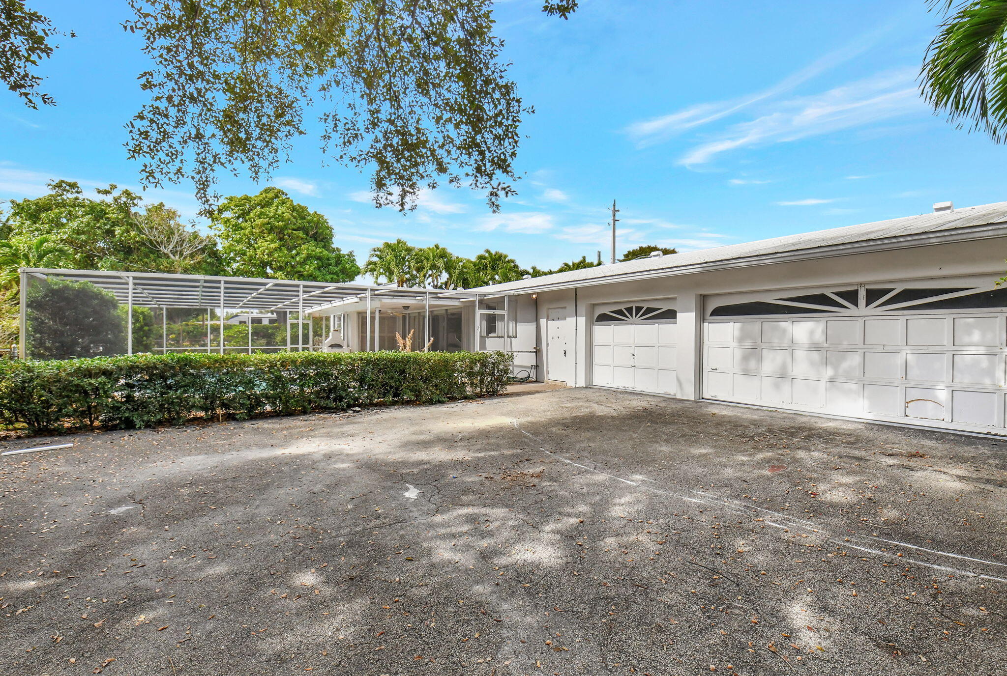 410 Spanish River Boulevard Boca Raton, FL 33431 - Photo 2 of 26 front view of a house with a yard