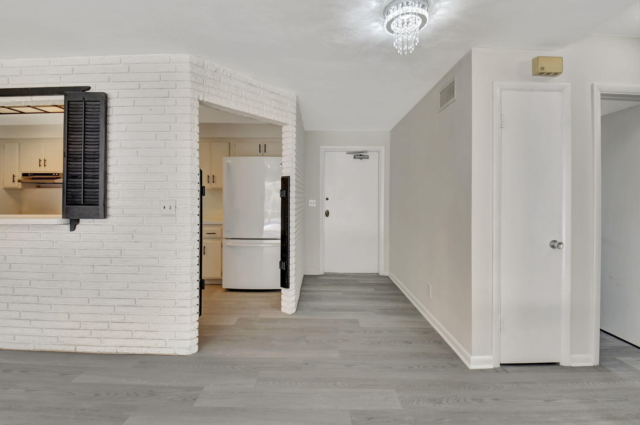 410 Spanish River Boulevard Boca Raton, FL 33431 - Photo 8 of 26 a view of a hallway with wooden floor and staircase