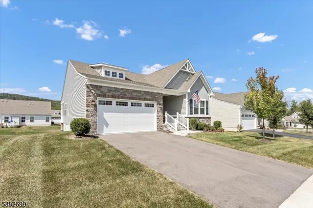 a view of a house with a yard and garage