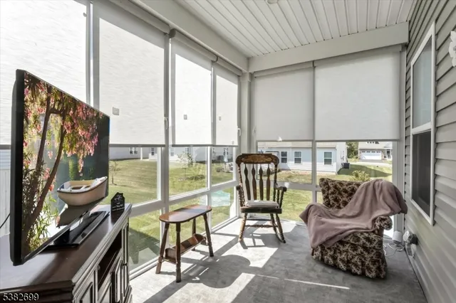 a living room with furniture and a floor to ceiling window