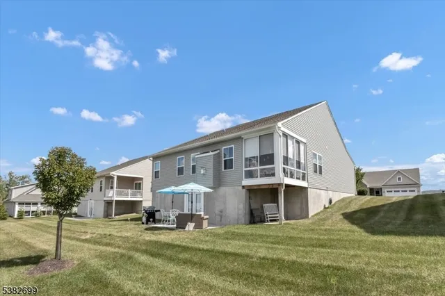 a view of a house with a yard and sitting area
