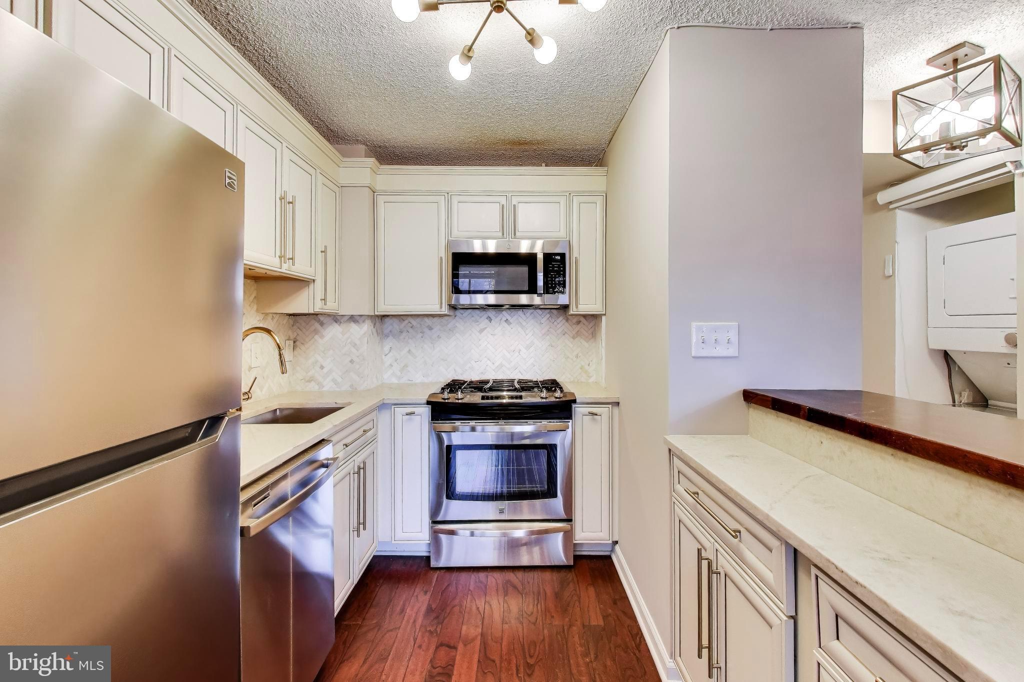 1245 13th Street Northwest, Unit 208 Washington, DC 20005 - Photo 12 of 19 a kitchen with a sink and a stove top oven