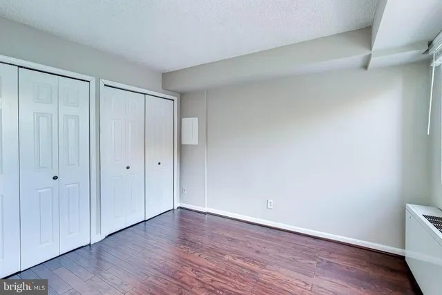 a view of an empty room and wooden floor