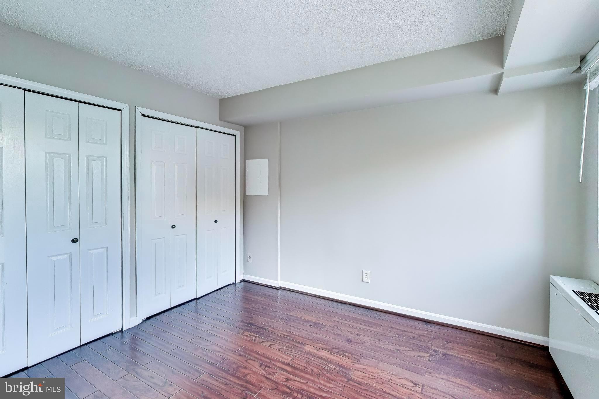 1245 13th Street Northwest, Unit 208 Washington, DC 20005 - Photo 14 of 19 a view of an empty room and wooden floor