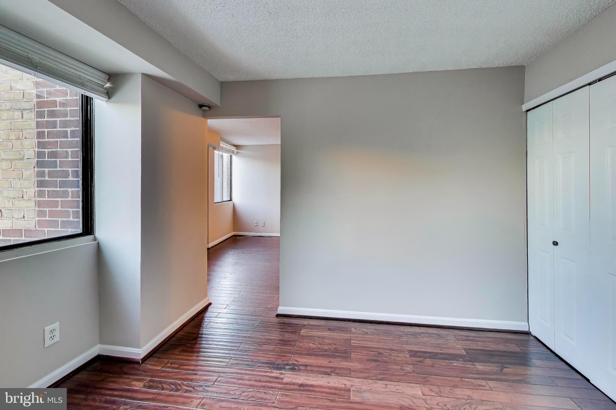 1245 13th Street Northwest, Unit 208 Washington, DC 20005 - Photo 15 of 19 a view of an empty room with wooden floor and a window