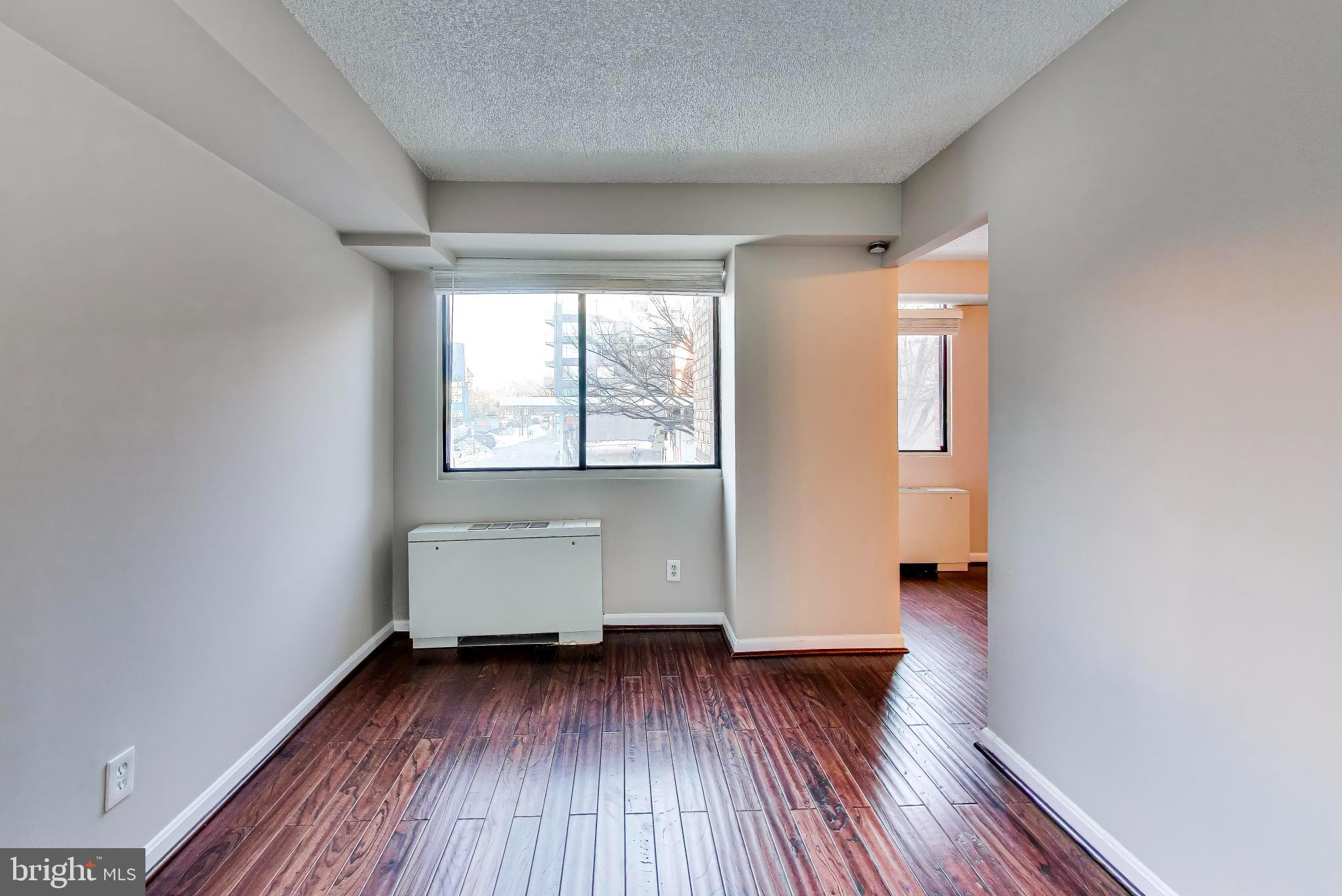 1245 13th Street Northwest, Unit 208 Washington, DC 20005 - Photo 17 of 19 an empty room with wooden floor and window