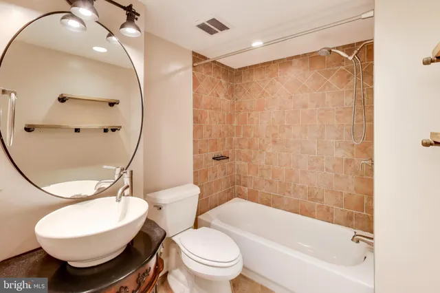 a bathroom with a toilet a sink and bathtub