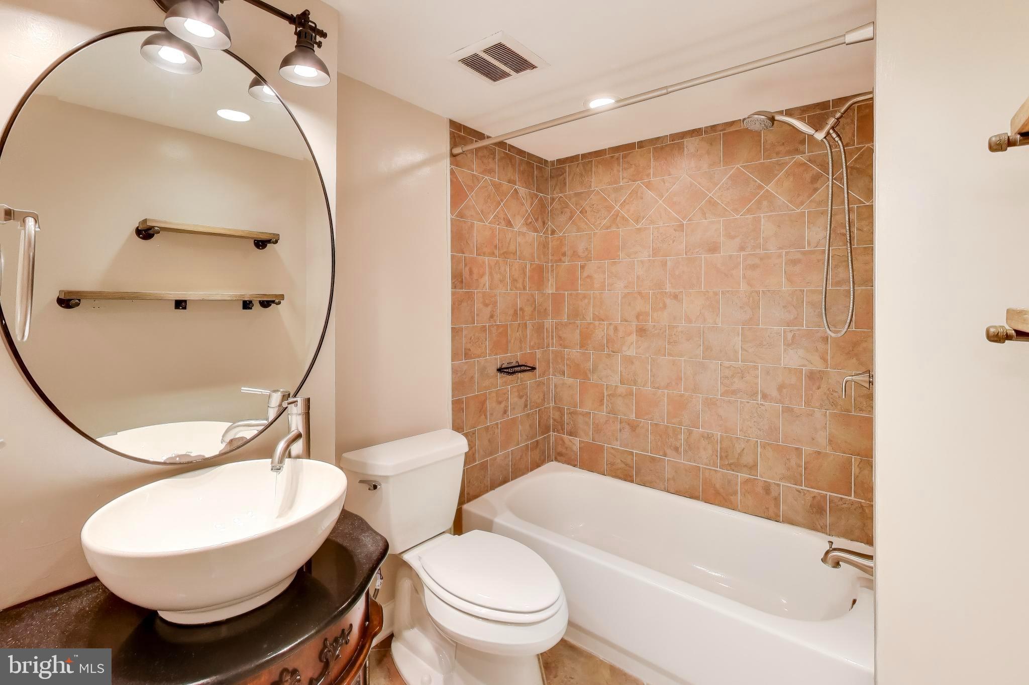 1245 13th Street Northwest, Unit 208 Washington, DC 20005 - Photo 18 of 19 a bathroom with a toilet a sink and bathtub