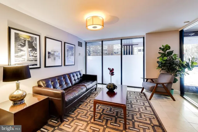 a living room with furniture and a lamp