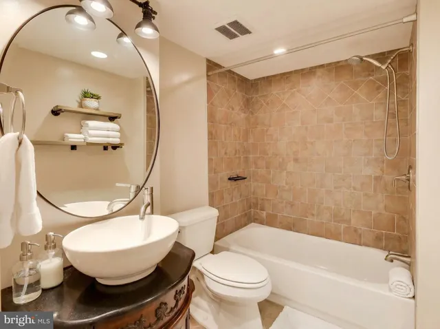 a bathroom with a sink toilet and a mirror