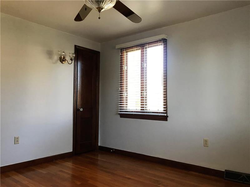 198 Seavey Road Pittsburgh, PA 15223 - Photo 13 of 18 The Master Bedroom is on the 1st Floor and has large windows in addition to the overhead light and ceiling fan plus the beautiful hardwoods!
