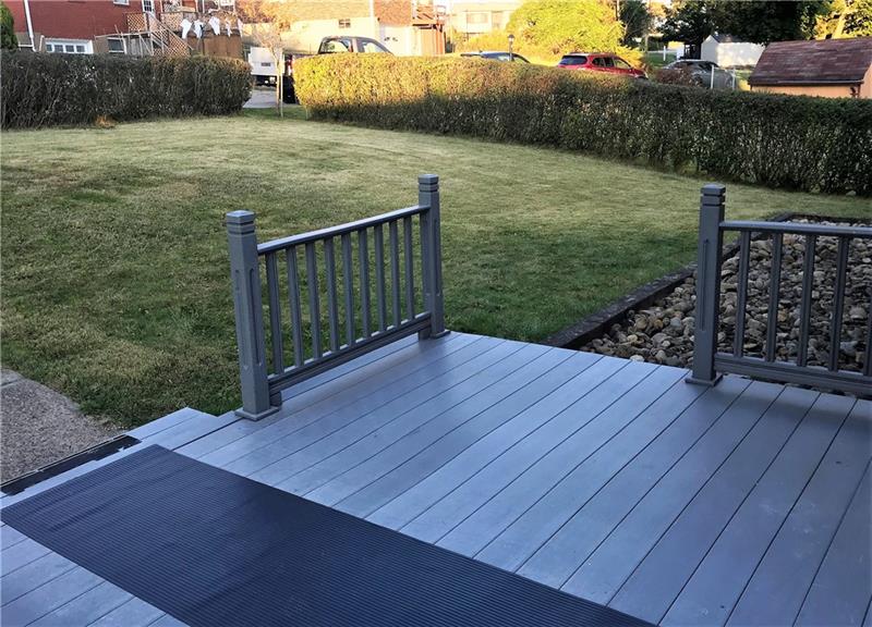 The deck with the nearly level back yard.
