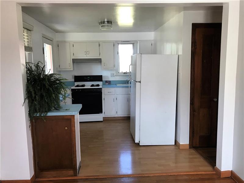 Upon entering from the side entrance, you find yourself in the kitchen.