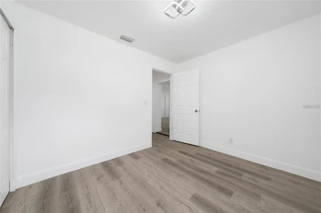 an empty room with wooden floor