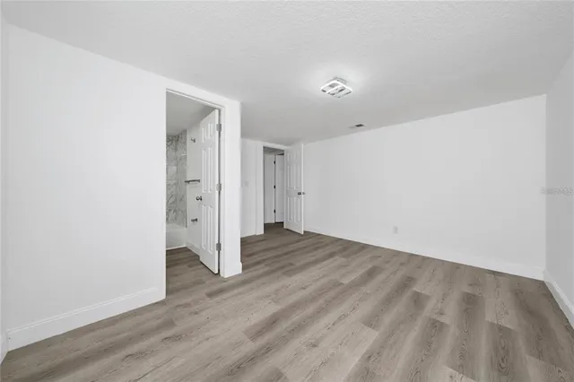 an empty room with wooden floor