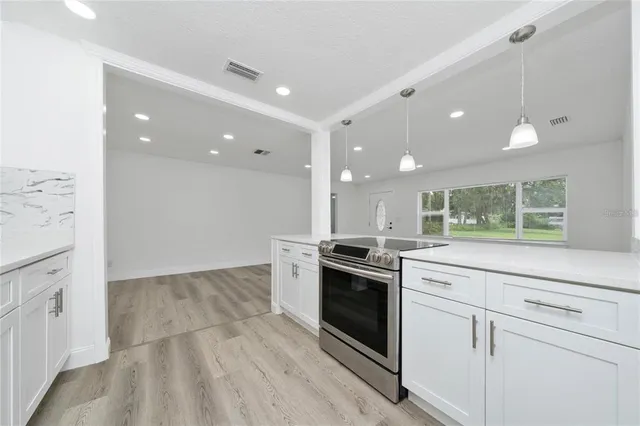 a kitchen with stainless steel appliances granite countertop a stove and a sink