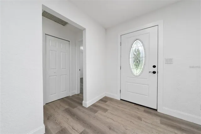 a view of a room with wooden floor