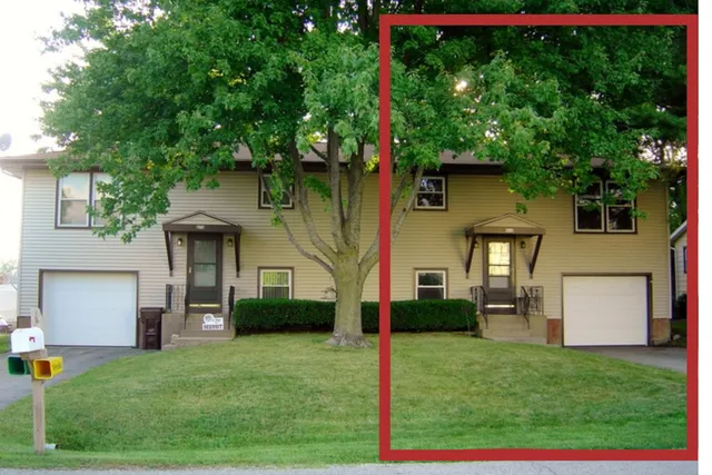 a front view of a house with a garden and yard