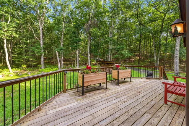 a view of a deck with wooden floor and outdoor seating