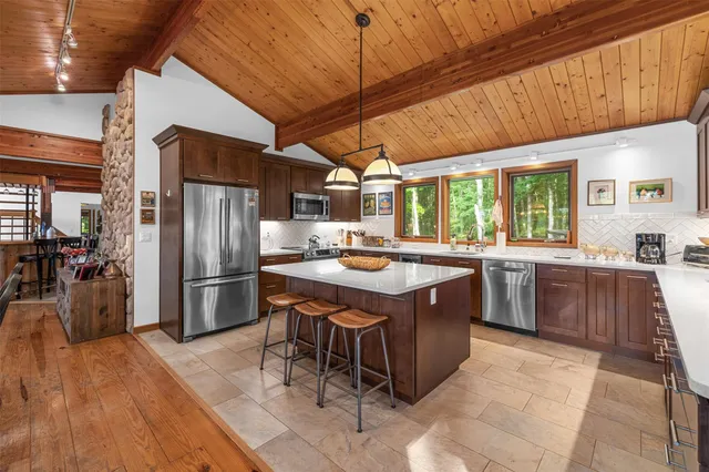 a kitchen with a sink a counter top space and stainless steel appliances