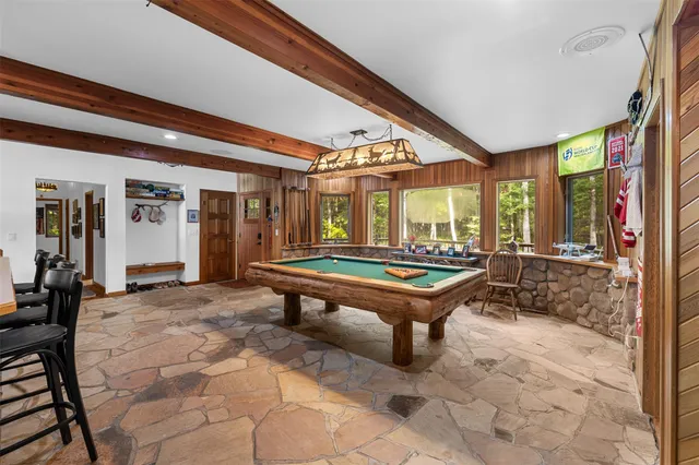 a room with pool tables and windows