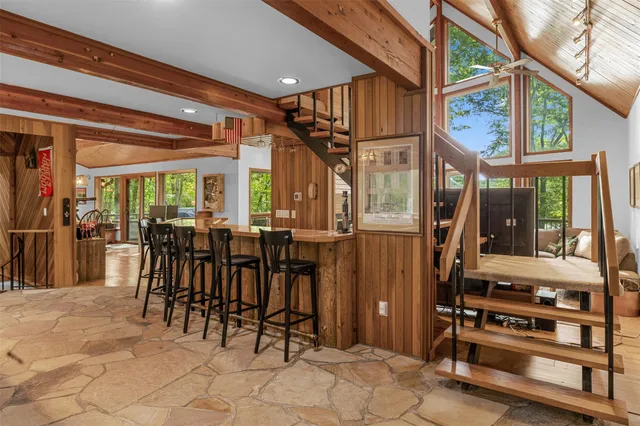 a view of a dining room with furniture and a window