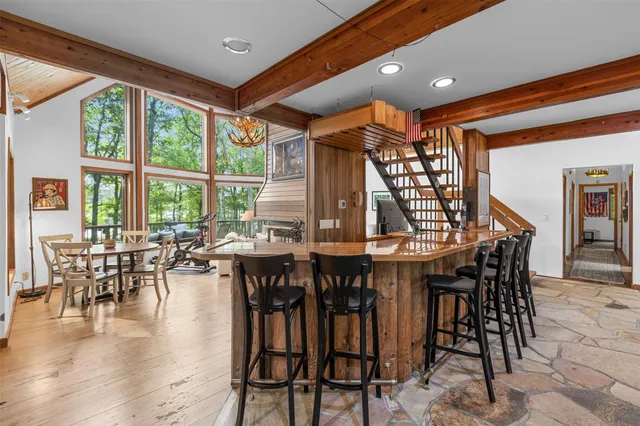 a dining room with furniture window and wooden floor