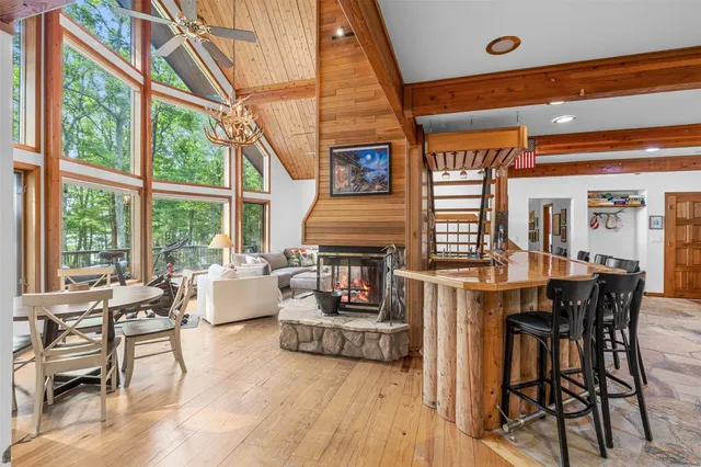 a living room with furniture and large windows