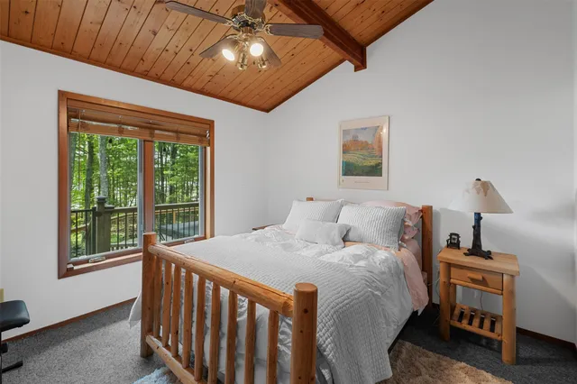 a bed sitting in a bedroom next to a window