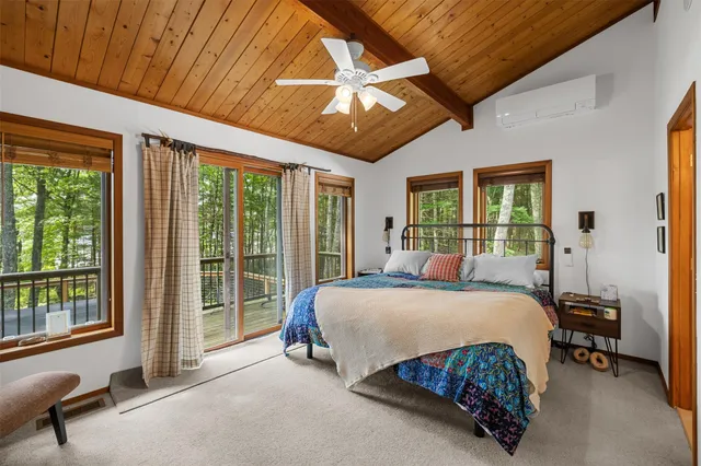 a bedroom with a large bed and a balcony view
