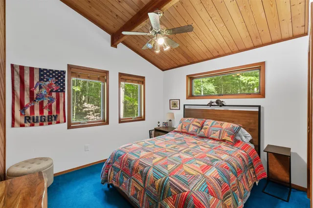 a bedroom with a large bed and a window