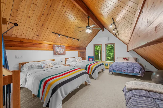 a bed sitting in a bedroom next to a window