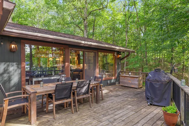 a view of roof deck with lawn chairs and wooden fence