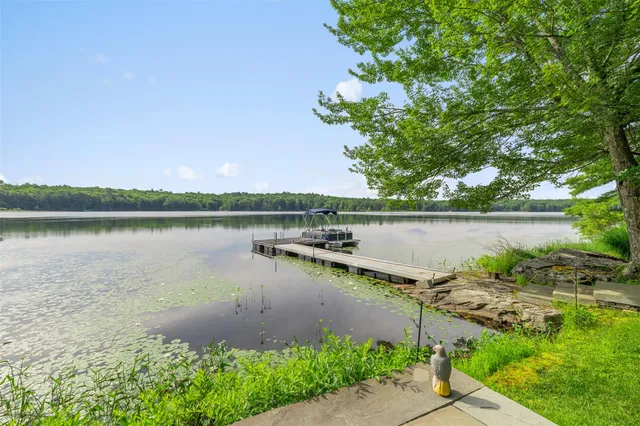 a view of a lake with houses in the back
