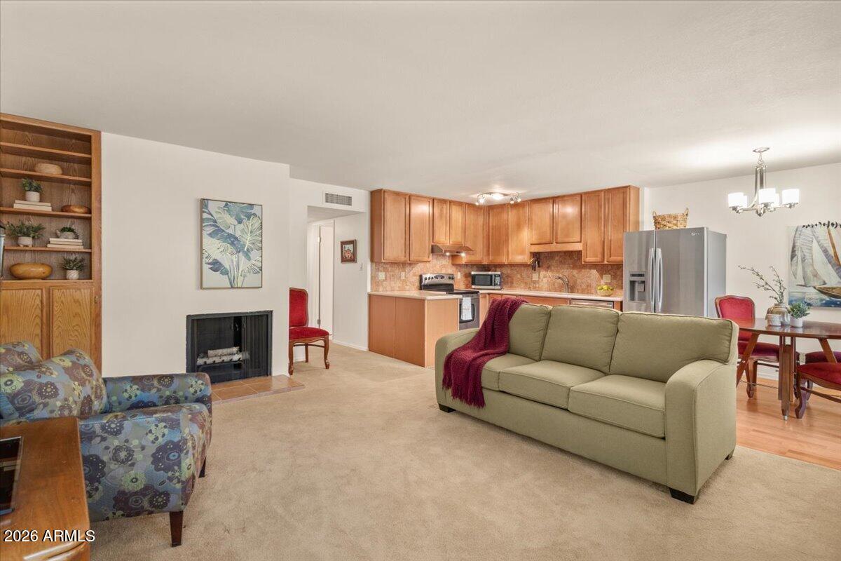 5525 East Thomas Road, Unit O12 Phoenix, AZ 85018 - Photo 15 of 27 a living room with furniture and a fireplace