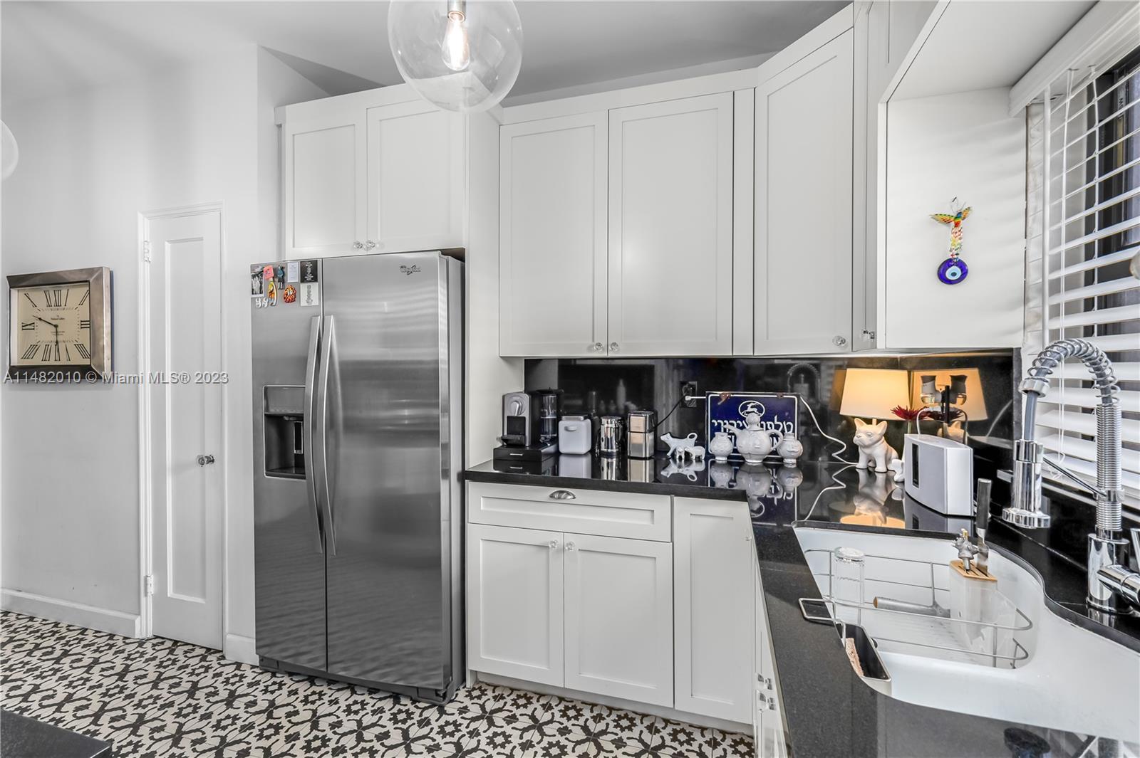 28 Southwest 26th Road Miami, FL 33129 - Photo 16 of 38 a kitchen with refrigerator and cabinets