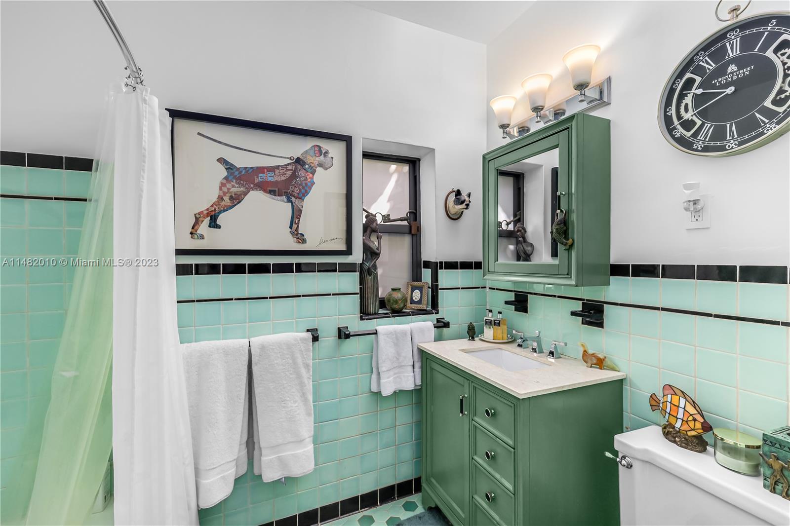 28 Southwest 26th Road Miami, FL 33129 - Photo 21 of 38 a bathroom with a sink and a mirror
