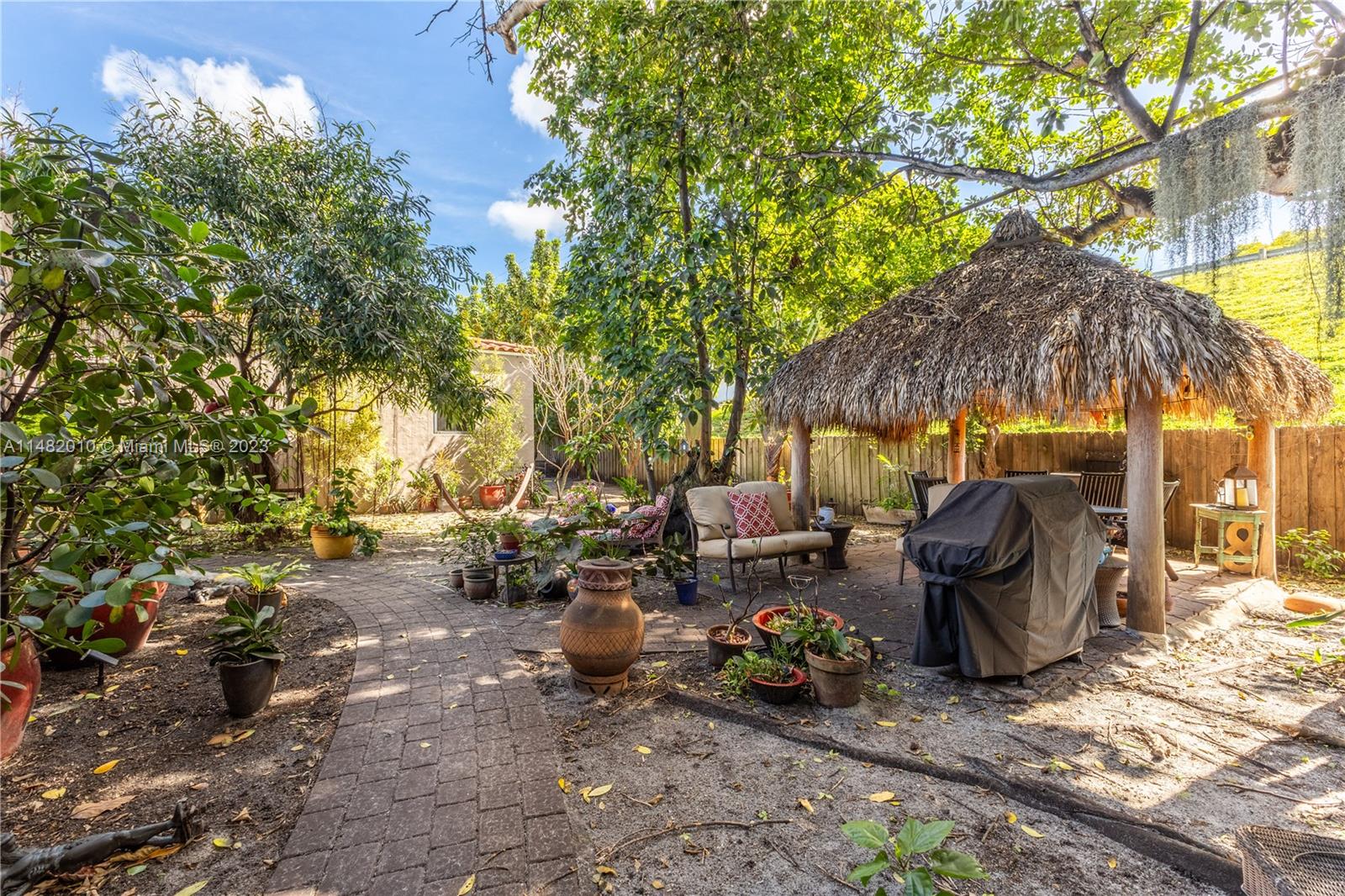28 Southwest 26th Road Miami, FL 33129 - Photo 29 of 38 a view of a patio with table and chairs under an umbrella