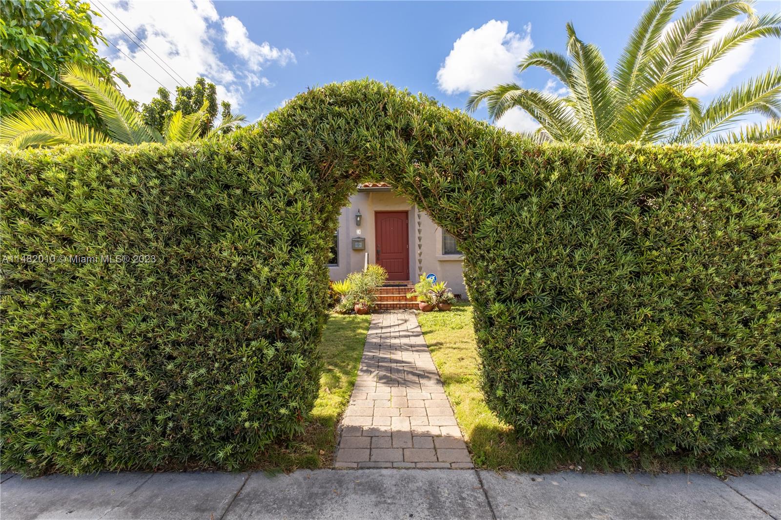 28 Southwest 26th Road Miami, FL 33129 - Photo 34 of 38 a front view of a house with a yard and potted plants