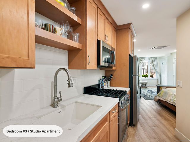 a living room with furniture kitchen view and a window