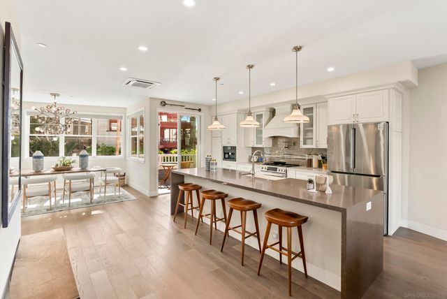 a dining room with chandelier a wooden table and chairs