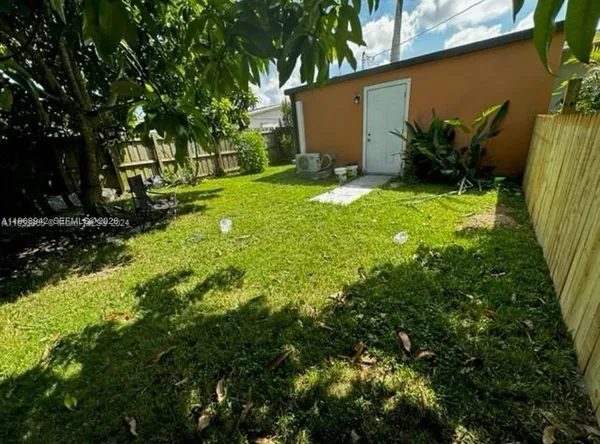 a backyard of a house with yard and outdoor seating