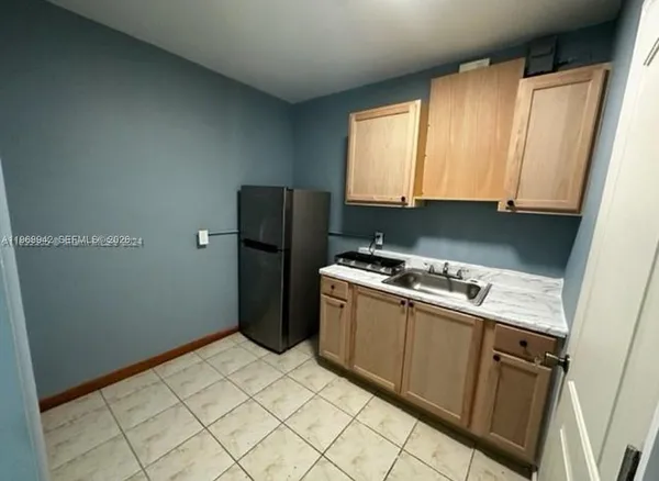 a kitchen with a refrigerator stove and cabinets