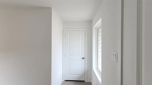 a view of a big room with wooden floor and windows