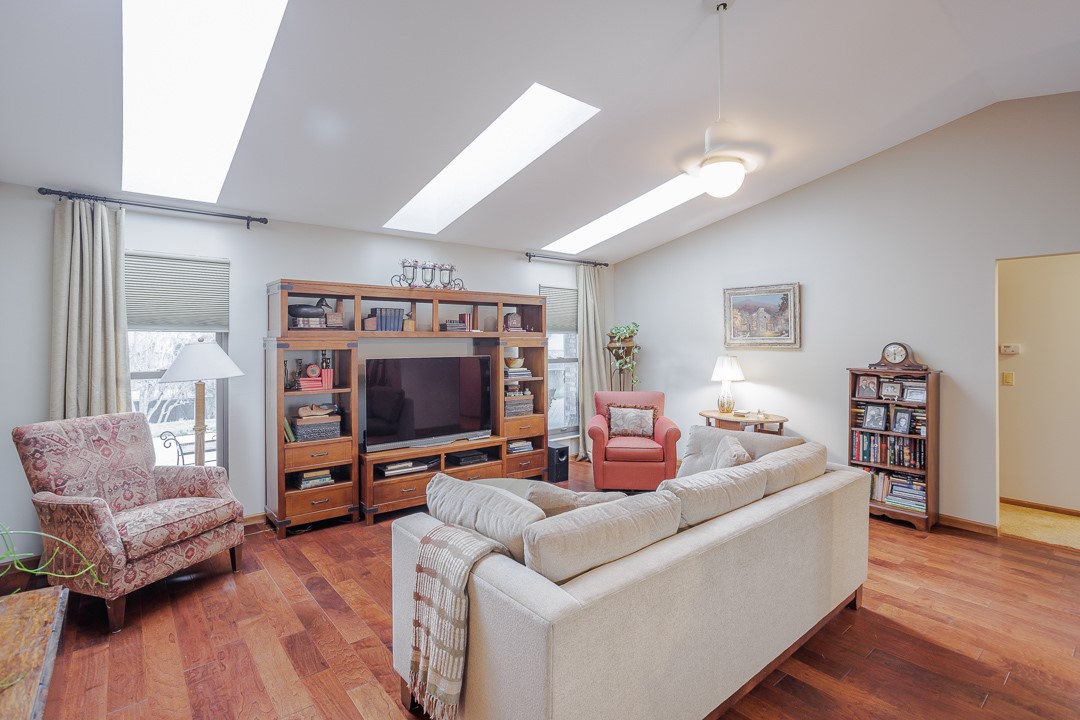 540 Basil Street Springboro, OH 45066 - Photo 3 of 32 Warm hardwood floors and vaulted ceilings with skylights define this inviting living area.