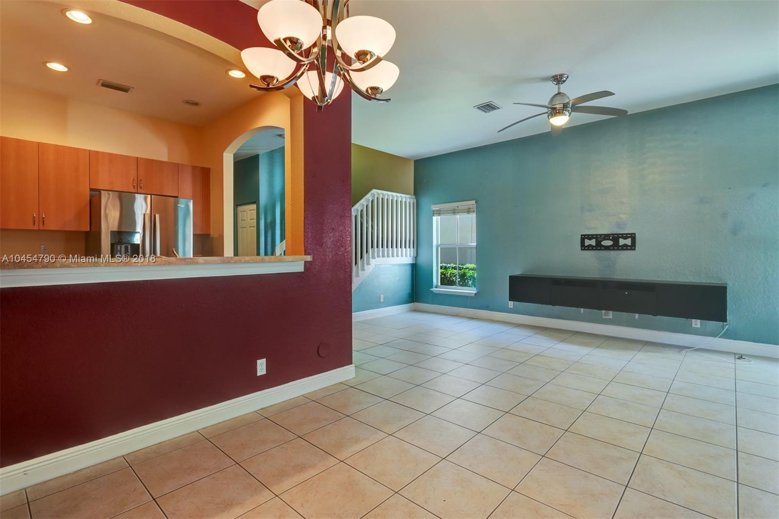 2127 Southwest 99th Way Miramar, FL 33025 - Photo 16 of 43 a view of a livingroom with a ceiling fan and chandelier fan