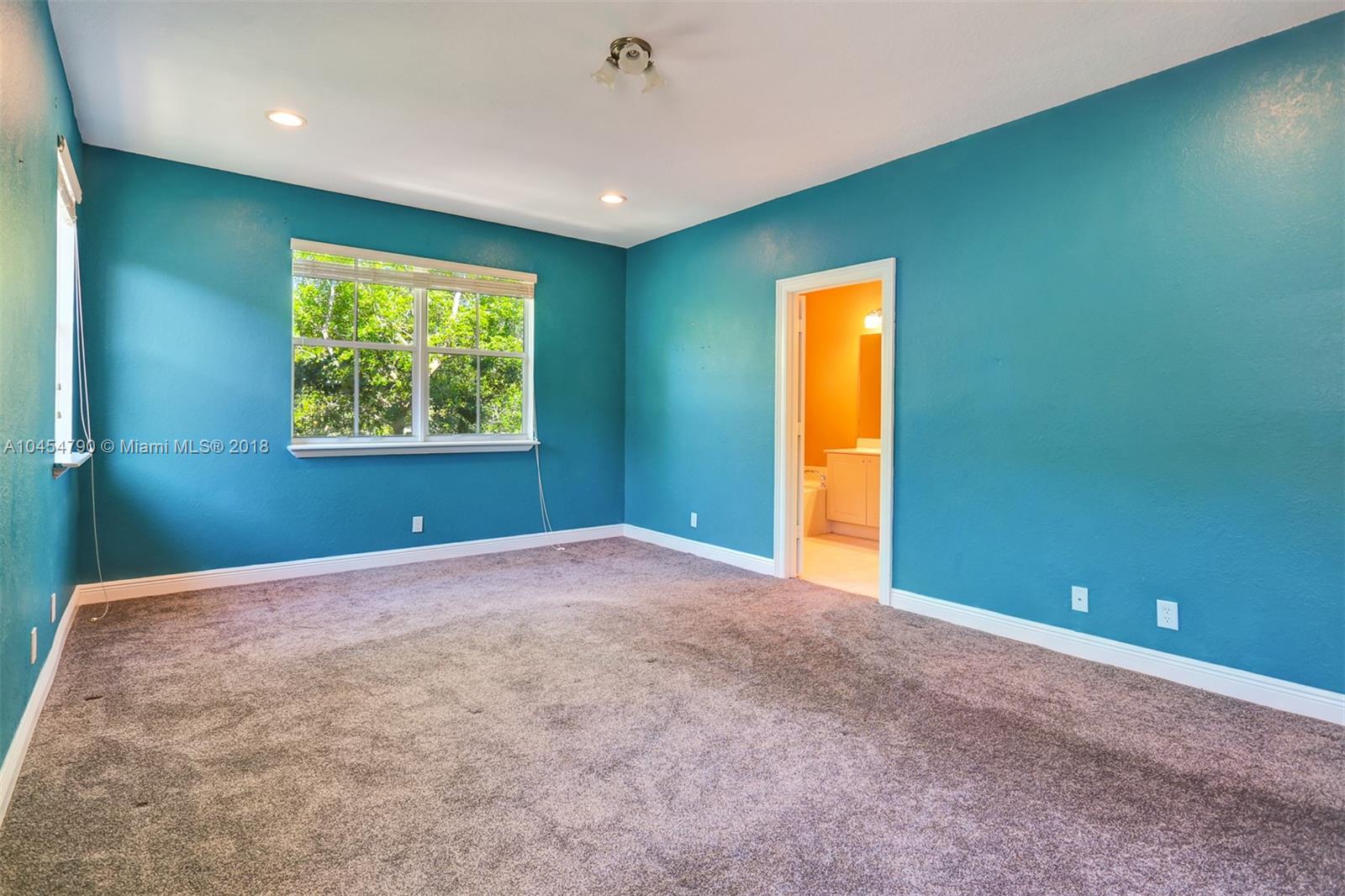 2127 Southwest 99th Way Miramar, FL 33025 - Photo 19 of 43 a view of an empty room with a window and a ceiling fan